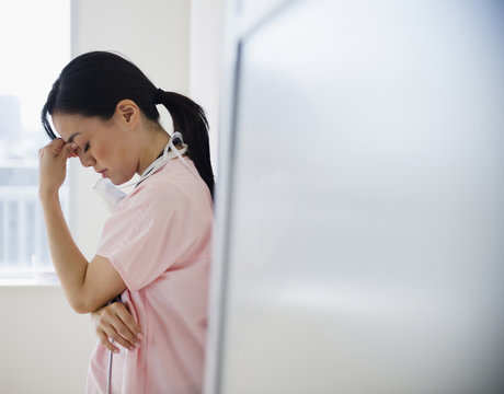Japanese nurse with a headache - Powered by Adobe