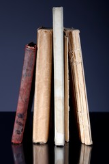 Pile of old books on grey background