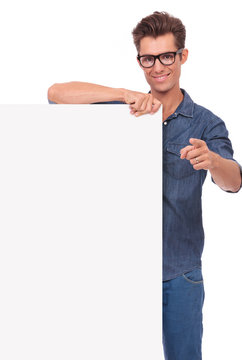 happy man with panel, pointing