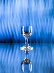 Glass of alcohol on disco background, party