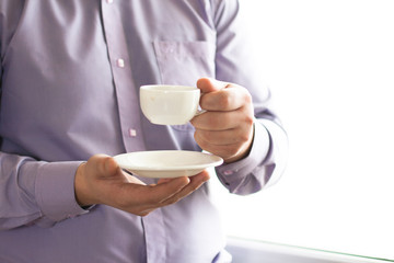 Businessman holding a cup of coffee