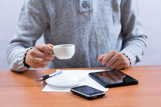 Businessman holding a cup of delicious coffee