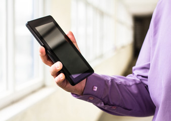A man holds up and running on a Tablet PC