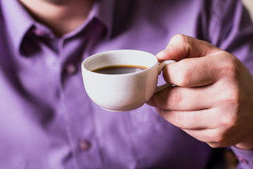 A man holding a cup of coffee