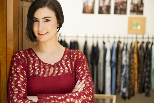 Hispanic woman standing in clothing store