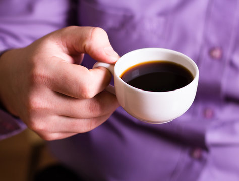 A man holding a cup of coffee