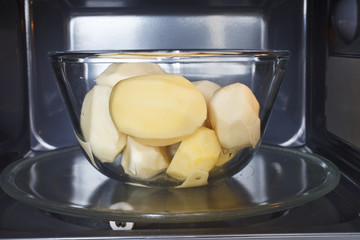 crude potatoes in a glass dish