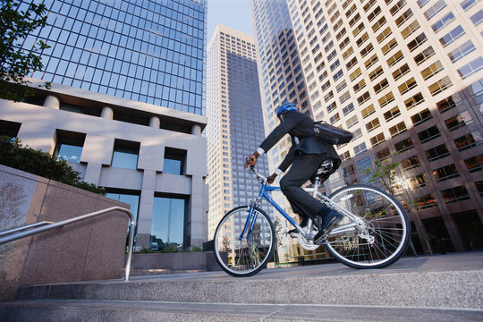 Businessman riding bicycle in city