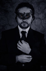 Fototapeta premium Artistic image of vampire masked mystery man and elegant black s