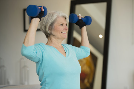 Caucasian woman exercising with hand weights
