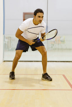 Hispanic man playing squash