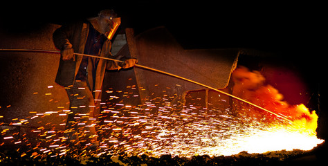 Hot Metal is Released by a Working Metallurgist. Metallurgy Production.