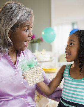 African American Girl Giving Grandmother A Gift