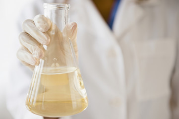 Cape Verdean scientist holding chemical in beaker
