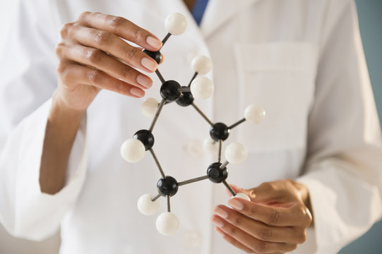 Cape Verdean scientist holding molecule model