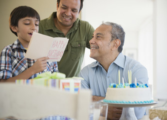 Hispanic grandfather, father and son celebrating birthday