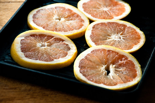 Sliced grapefruit in a panini pan