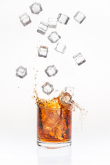 Ice cubes splashing bourbon