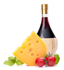 Red wine bottle, cheese and tomato still life