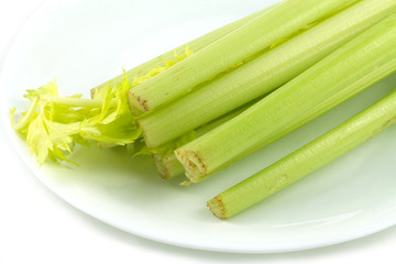 Celery stem on plate isolated on white closeup