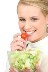 Blond girl eating salad