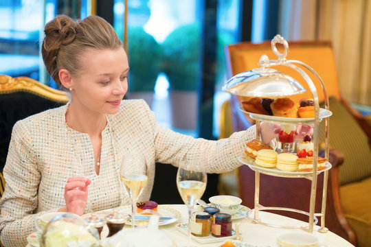 Beautiful young woman enjoying afternoon tea