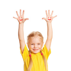Happy little child with smiley faces painted on his palms.