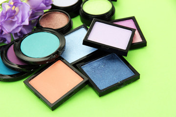 Beautiful bright eye shadows on green background