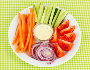 Assorted raw vegetables sticks in plate on table close up