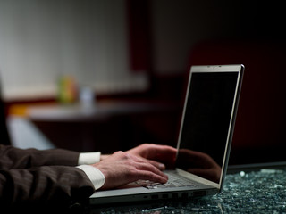 man's hands and laptop