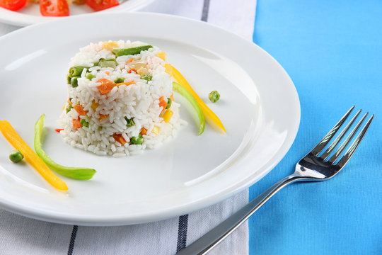 Delicious risotto with vegetables on table in cafe