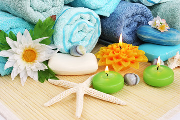 Fototapeta na wymiar Ręczniki, mydła, kwiaty, świece