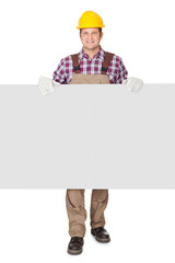 Construction worker presenting empty banner