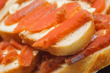 salted red pieces of fish on a bread. delicacy food
