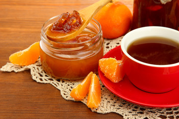 light breakfast with tea and homemade jam, on wooden table