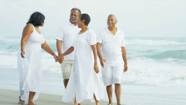 Retired Ethnic Couples Strolling Beside Ocean