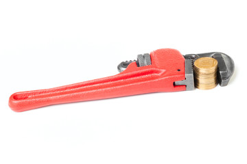 A gold coins in a red monkey wrench