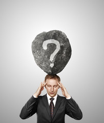 businessman and stone with question on his head - obrazy, fototapety, plakaty