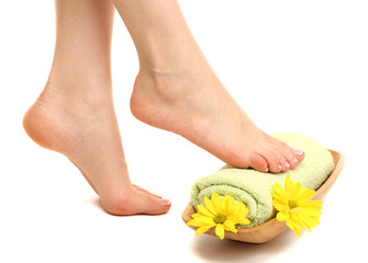 Obraz na płótnie Canvas Female feet with towel - spa concept, isolated on white