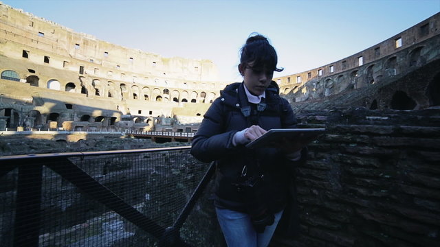 Woman using tablet inside the colosseum