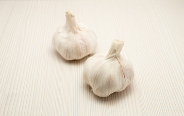 two garlic close up and wood background