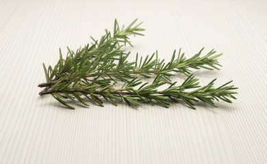 branch of rosemary on a wooden