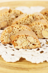 Aromatic cookies cantuccini on wooden plate close-up