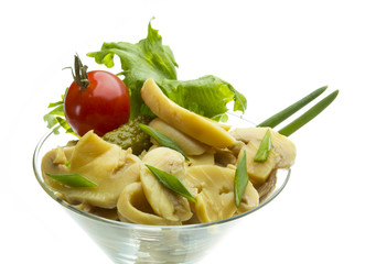Marinated mushrooms in white saucer isolated on white