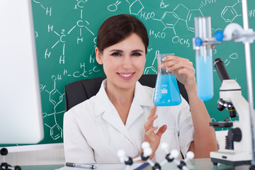 Female Scientist Holding Chemical