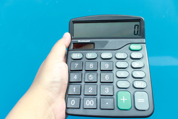 woman's hands with a calculator