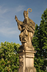 Fototapeta na wymiar Saint Augustine statue holding, Charles Bridge Prague
