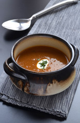 Spicy tomato soup on a dark cloth