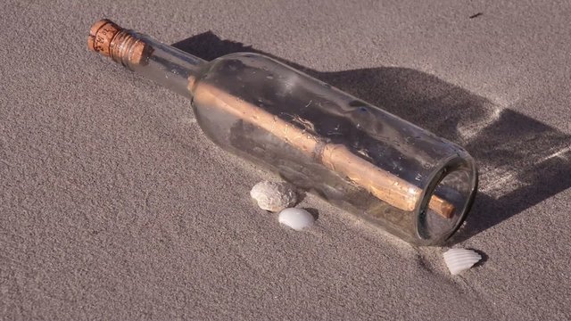 Bottle Message with waves on the beach