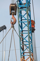 Weathered crane hook detail with hanging load
